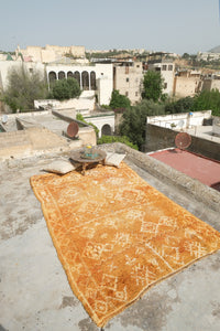 Henna dyed vintage Moroccan rug with white motifs