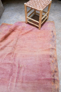 Handwoven vintage Moroccan rug with a beautiful palette of peach and pink